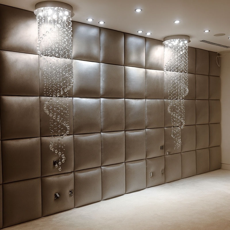 Luxurious padded wall panels with spiral crystal lighting, creating a modern, elegant interior design by Solo Home Decor.
