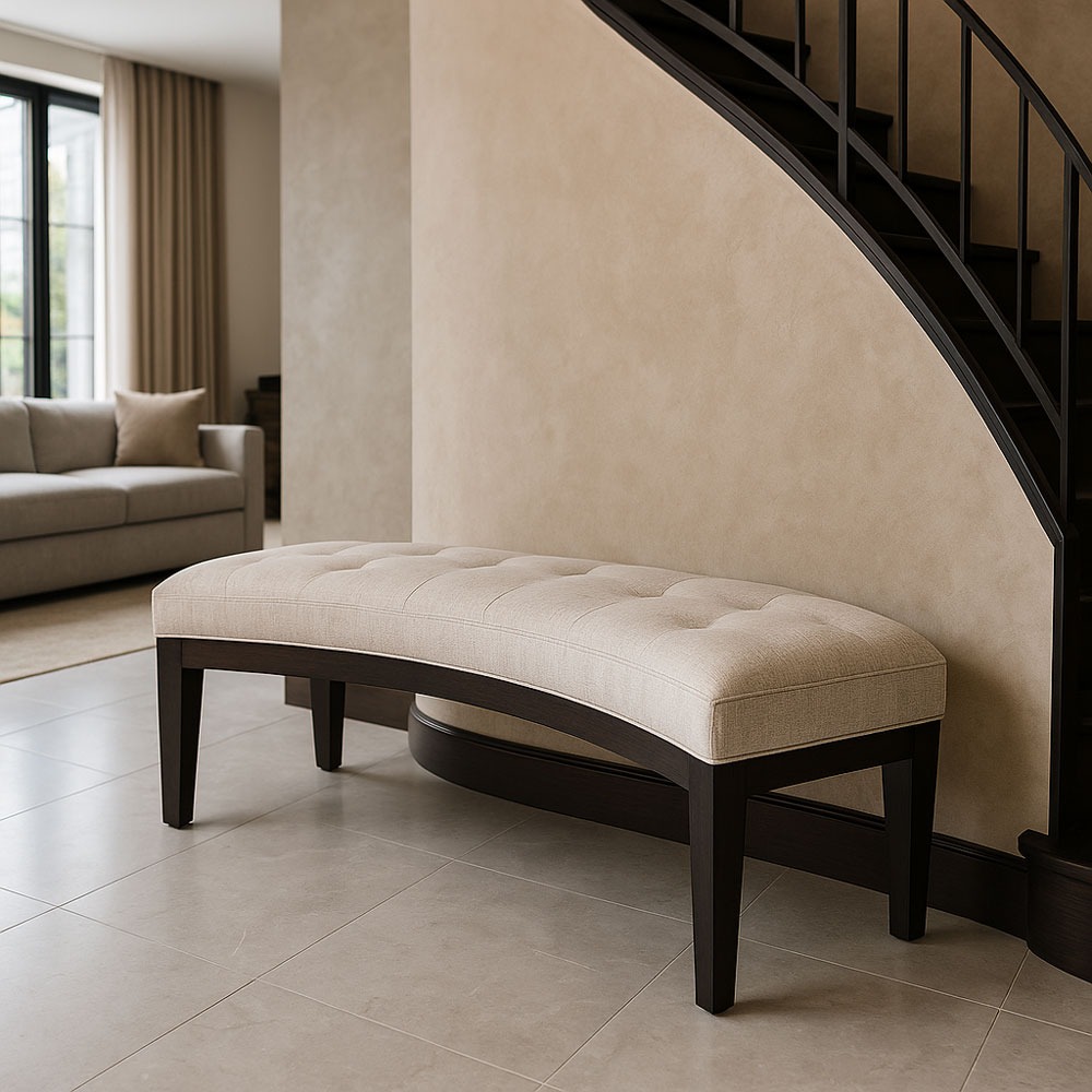 Modern luxury interior featuring Solo Home Decor’s custom curved bench with tufted fabric, showcased under a sleek staircase.