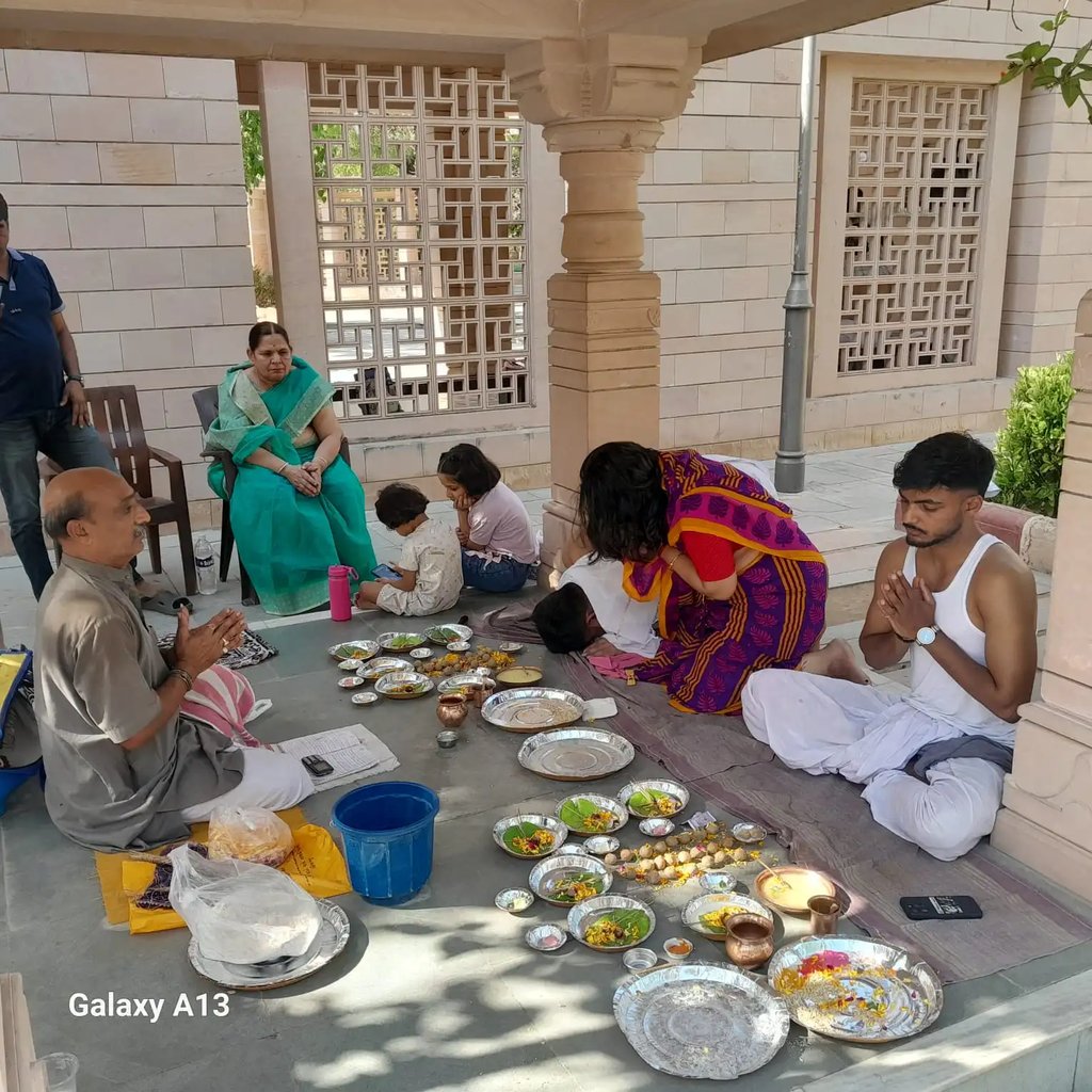 Three-generation Hindu family completing Matrugaya Pooja together at sacred Bindu Sarovar Siddhpur Gujarat