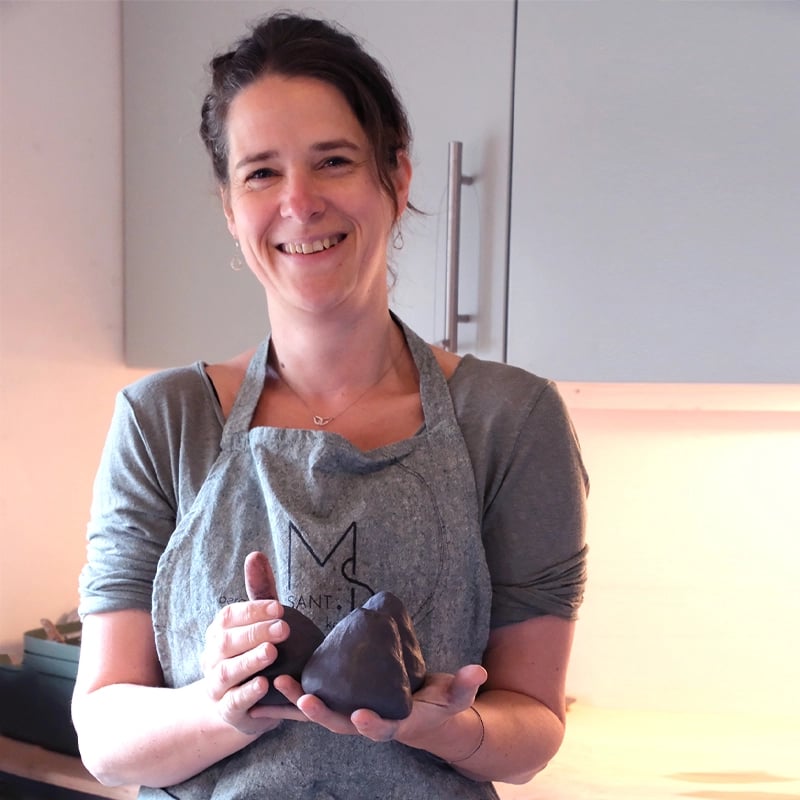 Keramist Maartje met bollen klei in haar handen klaar voor een keramiek cursus in haar atelier in Breda