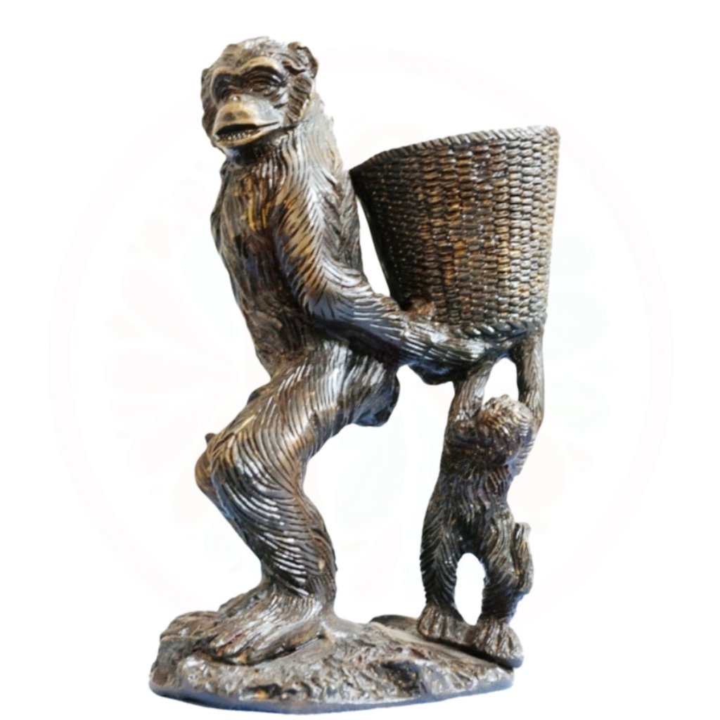 a statue of a monkey holding a basket with a basket