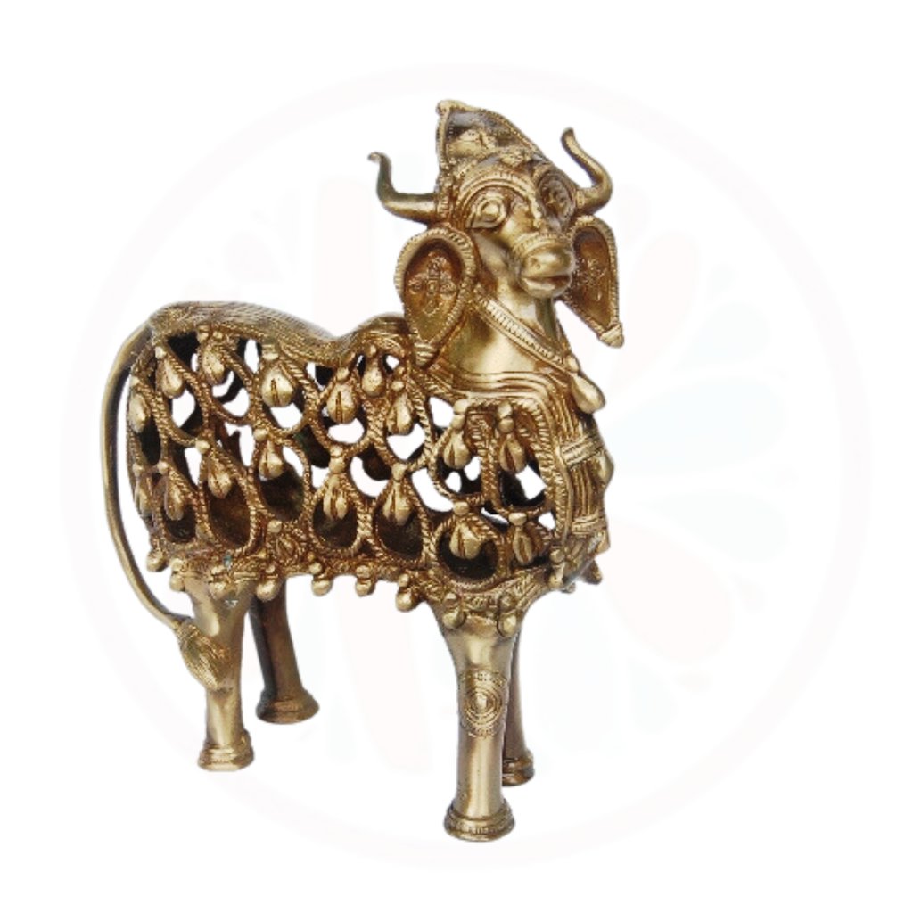 a gold colored metal animal statue of a goat