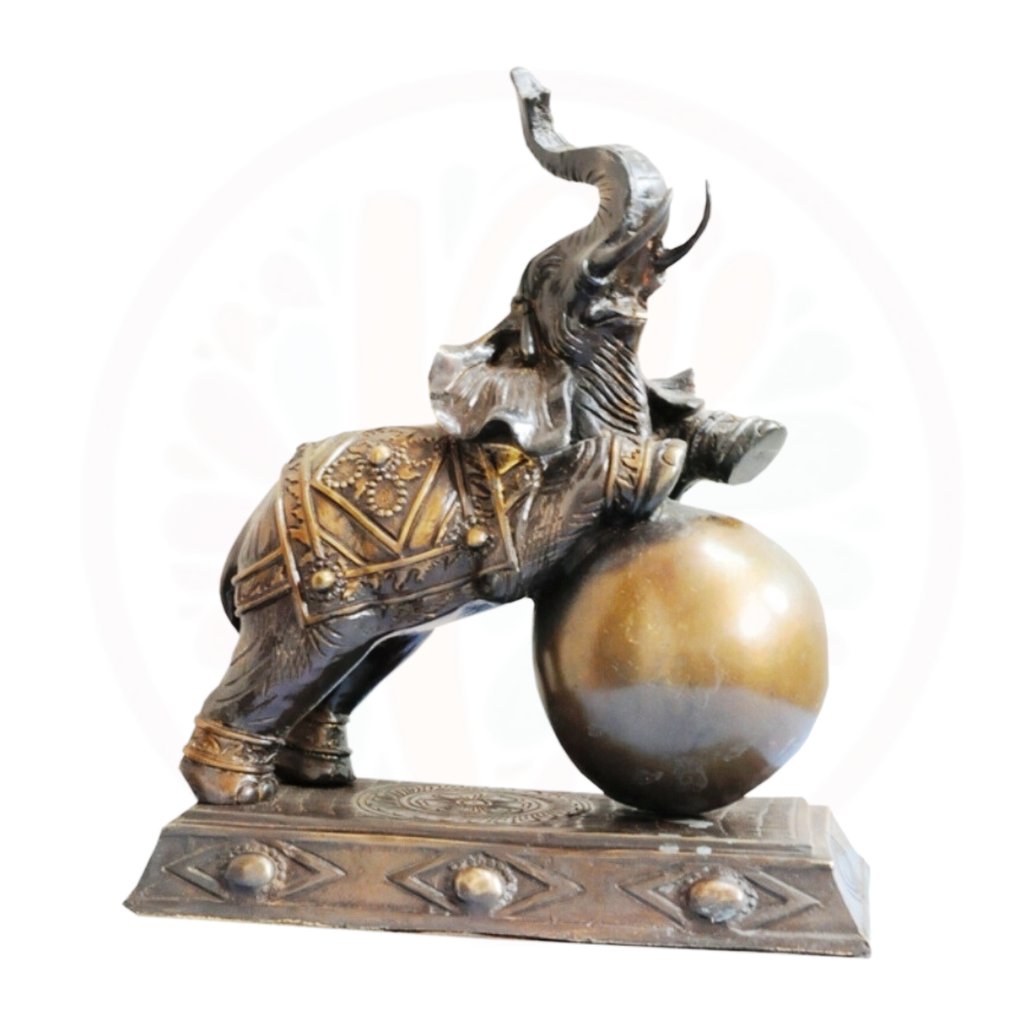 a statue of a man riding a elephant on a ball