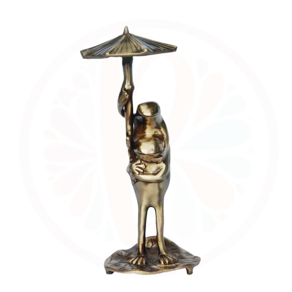 brass frog under a umbrella