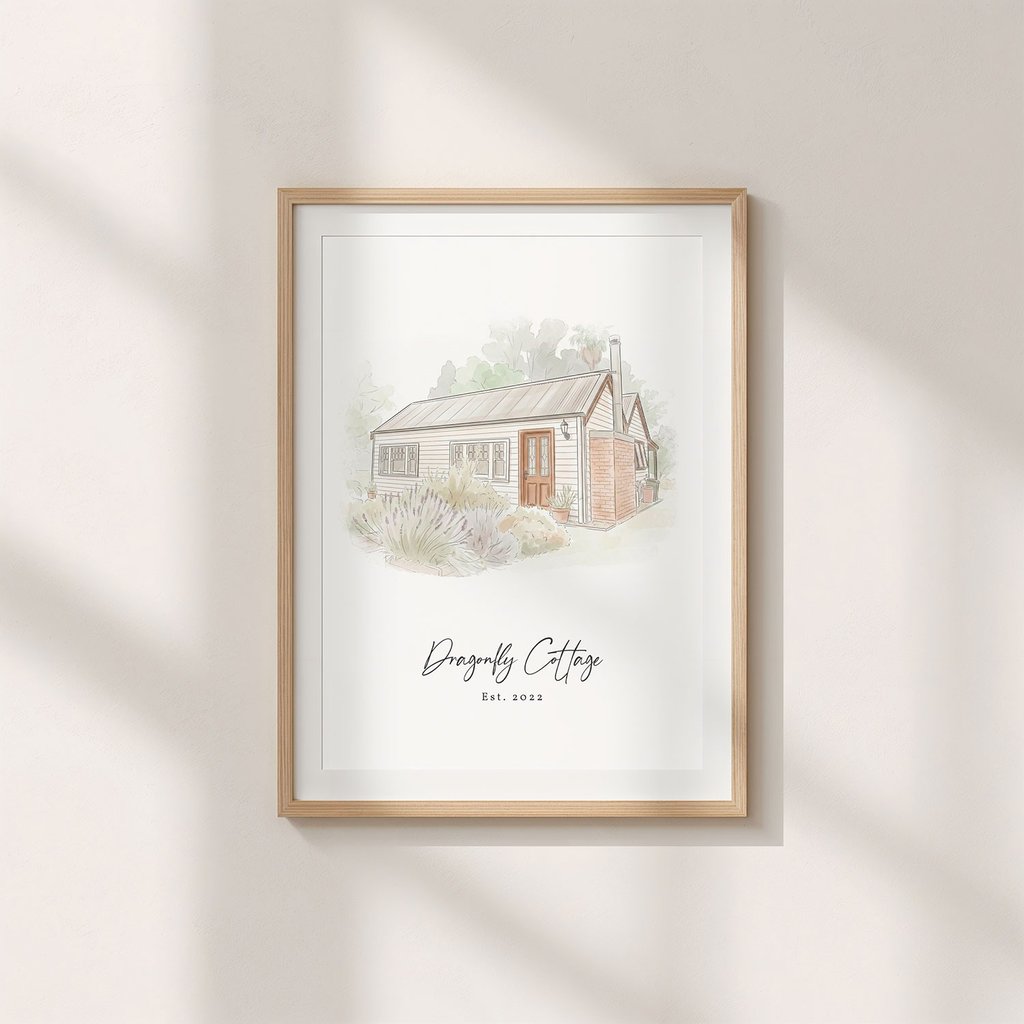 A minimalist ink and watercolor painting of a cottage hangs on a wall