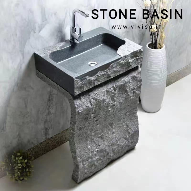 a stone sink with a stone sink and a vase with flowers
