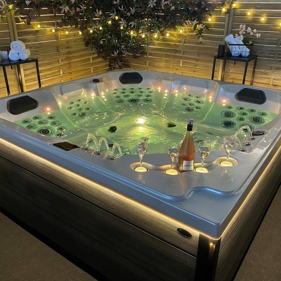 a hot tub with candles and candles on a patio