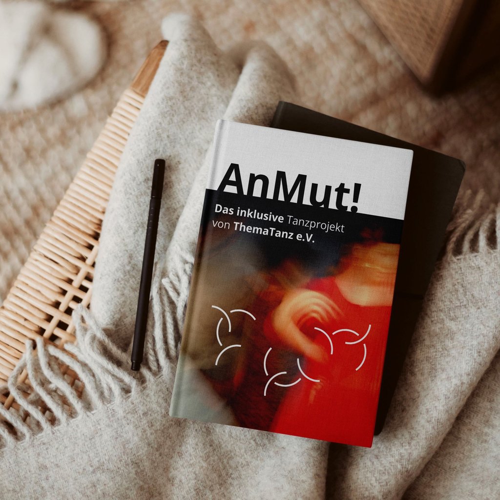 Gedruckte Broschüre „AnMut!” liegt auf Korbtisch