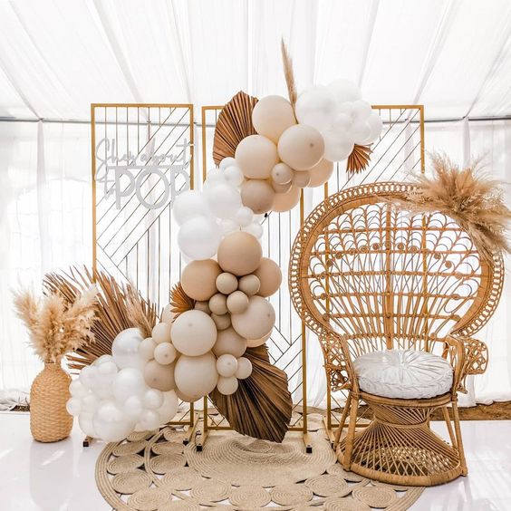 Adorable balloon garland draped around the high chair, perfect for a 1st birthday celebration.