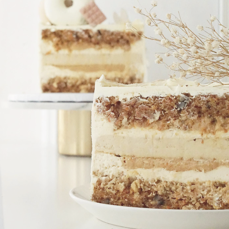 a cake with a white frosting and a flower