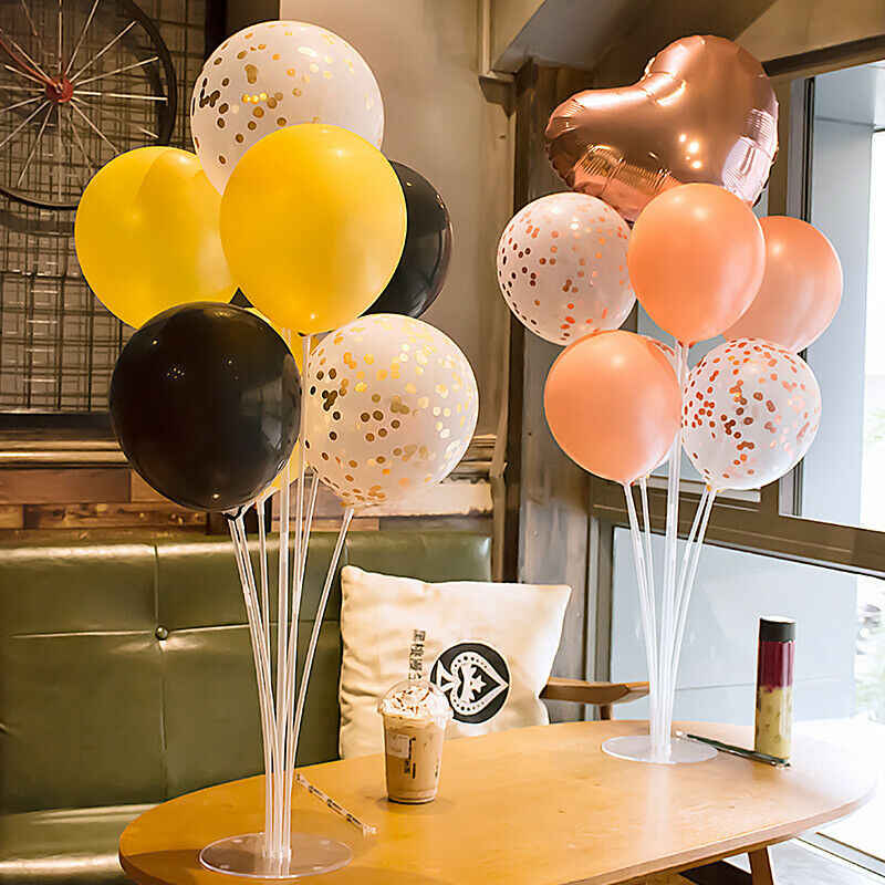 Festive balloon centerpieces adding charm to 1st birthday party tables.