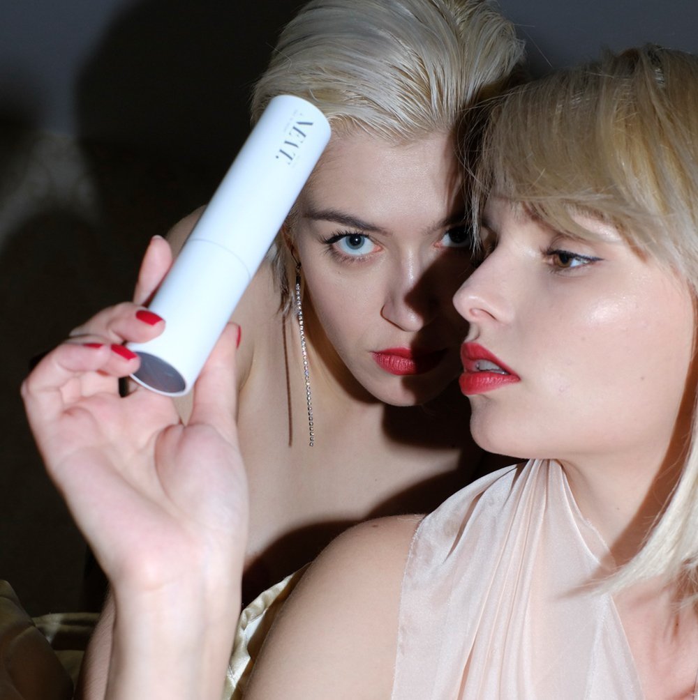 two women in evening wear, one is holding ALL YOU NEAT.´s Ultimate Age Defense Face Cream