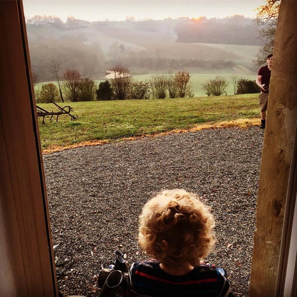 A little boy looking out over the countryside.