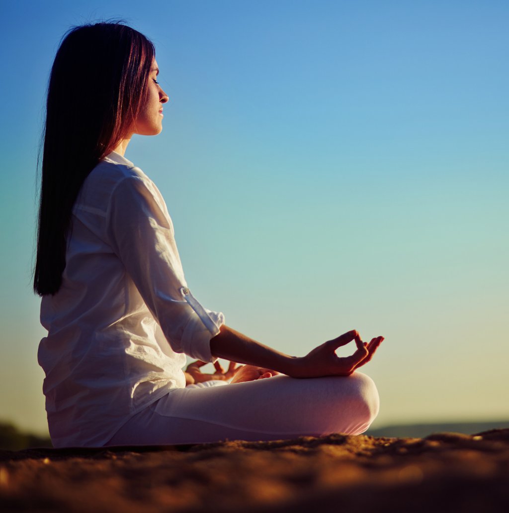 a woman sitting in a meditation position