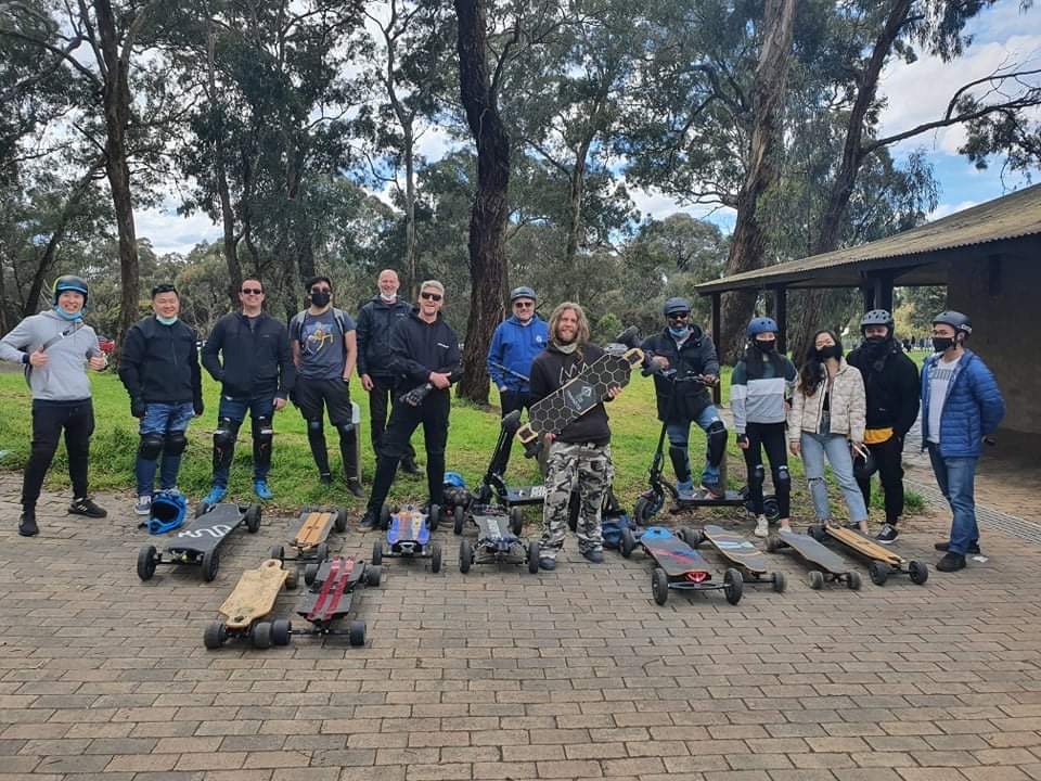 group of guys with electric skateboards having fun riding