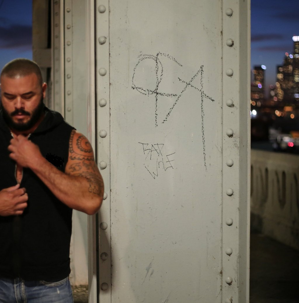 a man with a beard and tattoos on his chest