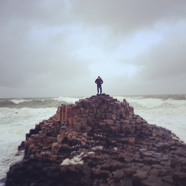 A man stood on Giant's Causeway, Ireland
