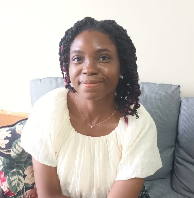 woman smiling with grey chair background