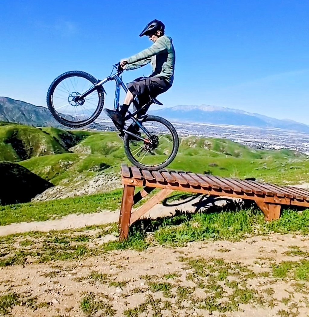 mountain biker riding off drop