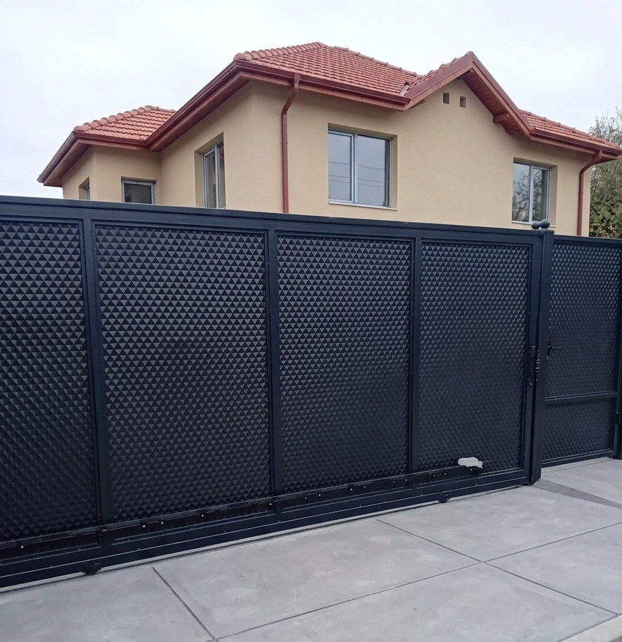 Modern black metal sliding gate with textured 3D pyramid pattern for residential home security.