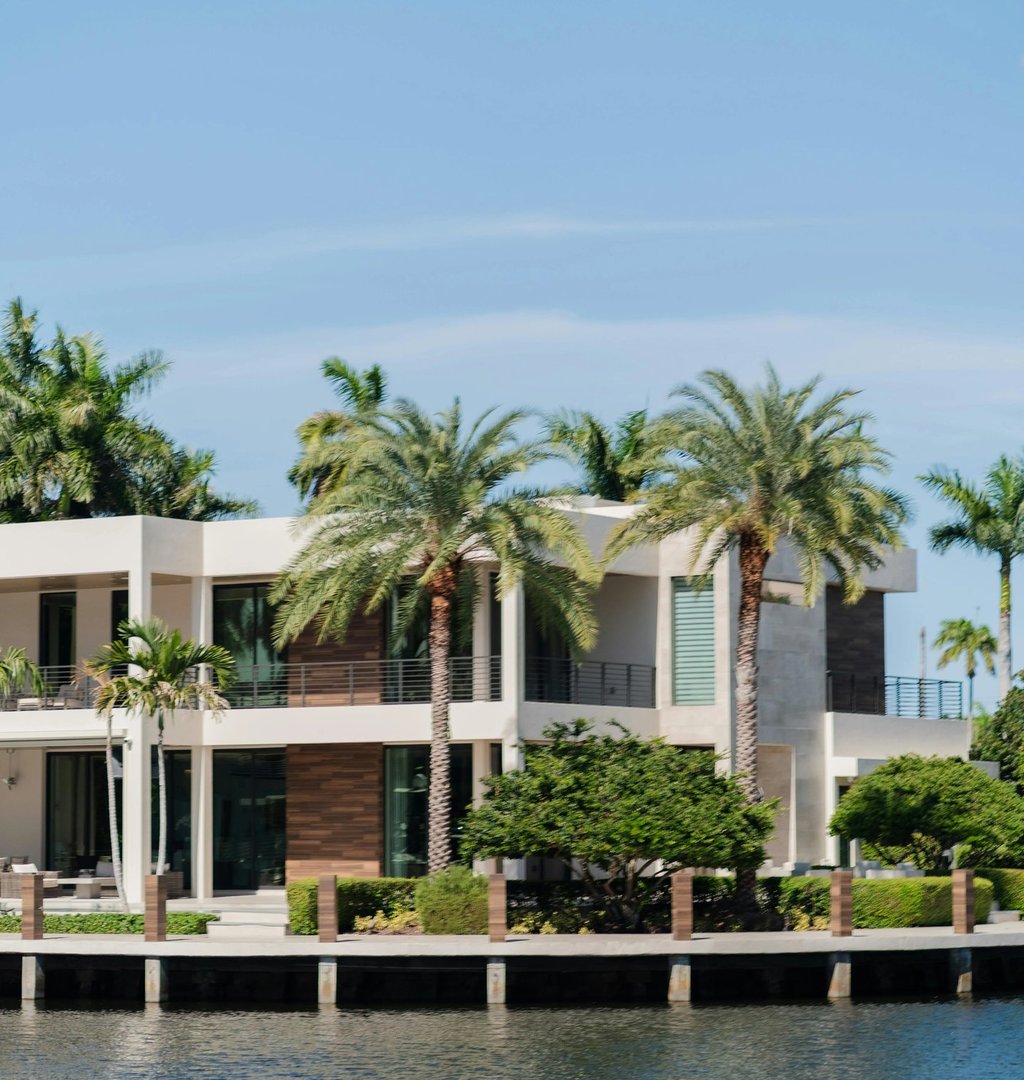 waterfront home with palm trees