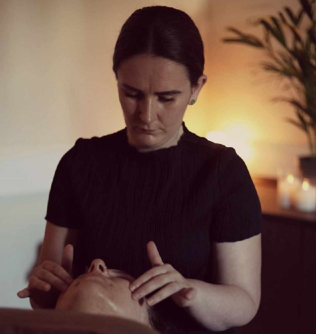 Emily Britten providing acne facial treatment for skin transformation client