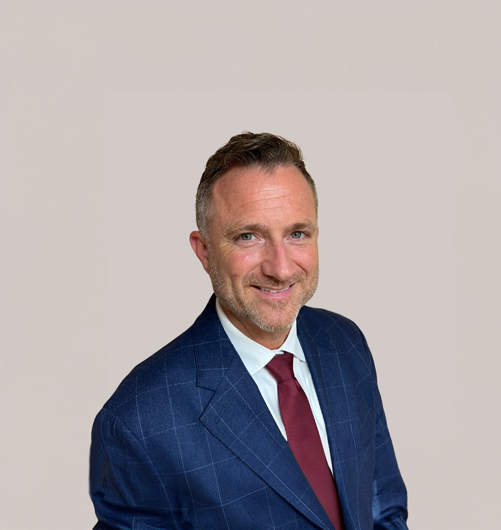 a man in a suit and tie smiling
