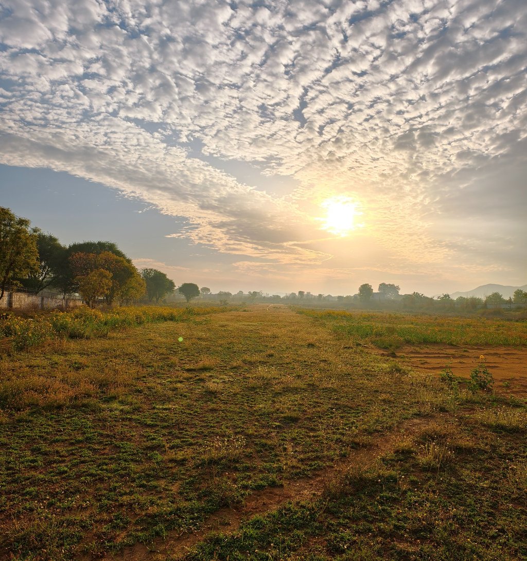 Golden morning sunrise over the grass runway at Go Fly Zone under a dramatic altocumulus cloud sky.