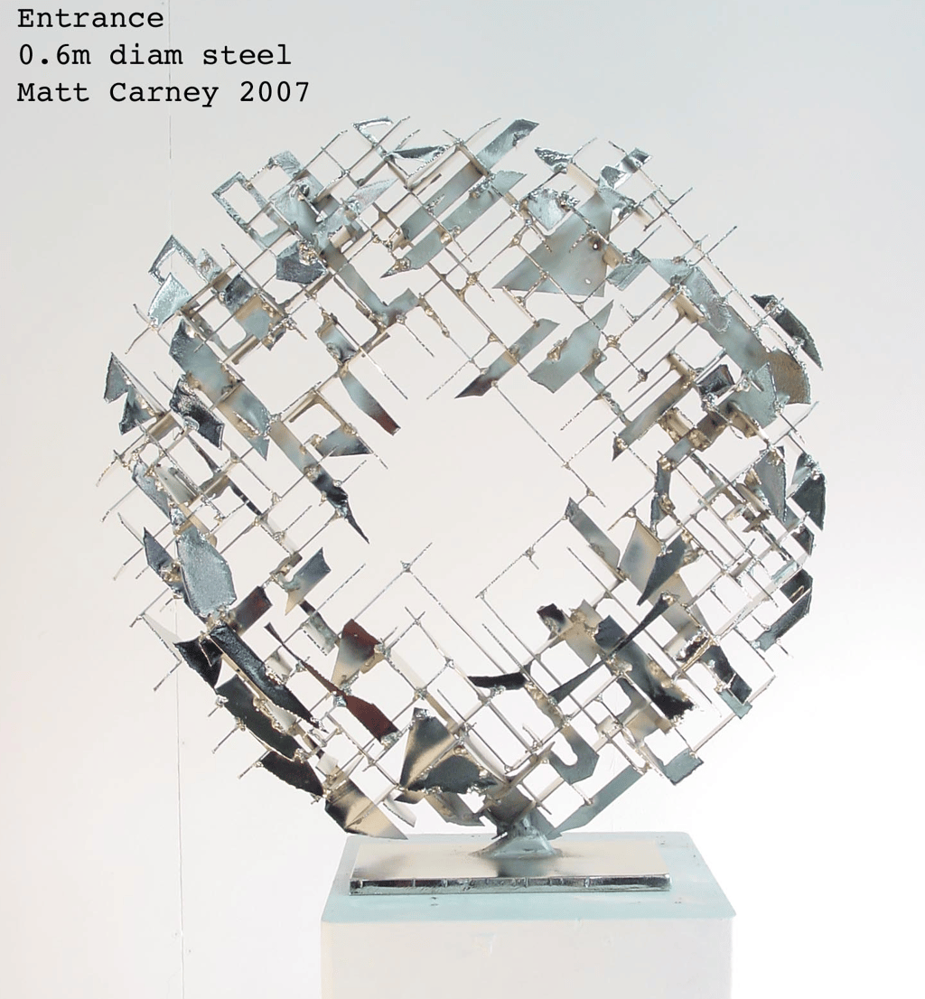a silver cross-hatched circle sculpture  