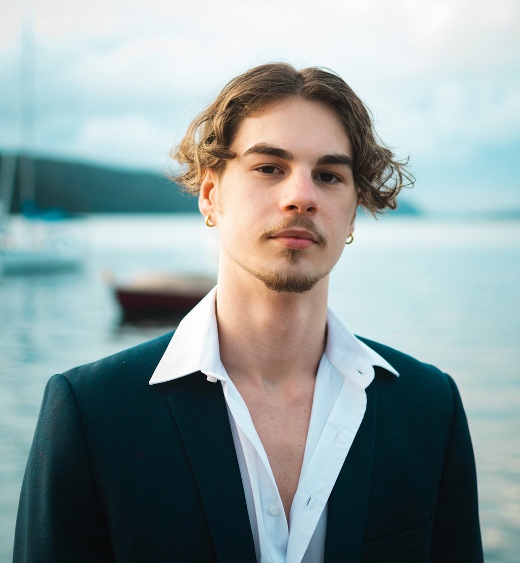 a man in a suit and white shirt