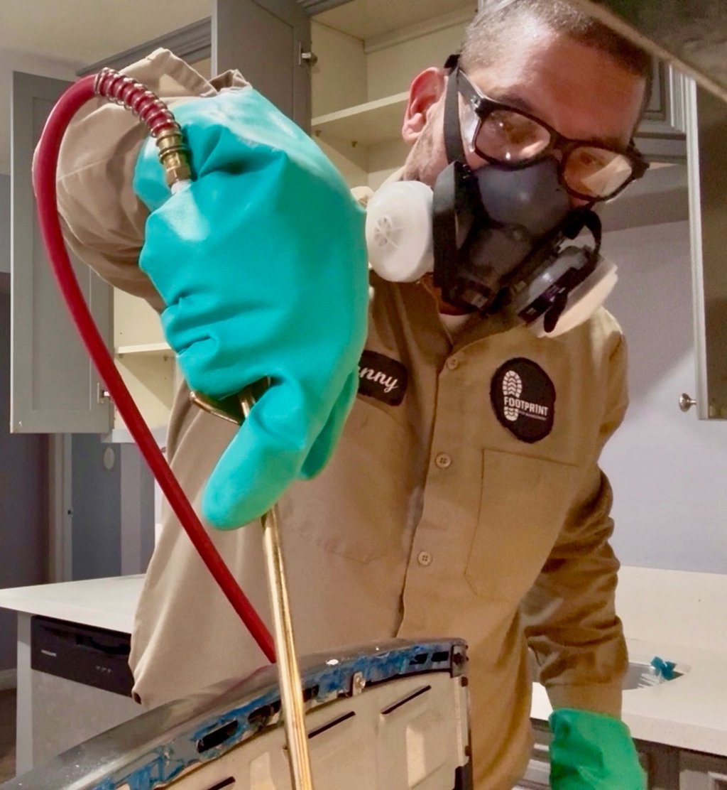 Exterminator on a German roach treatment in Menifee CA Footprint Pest Management