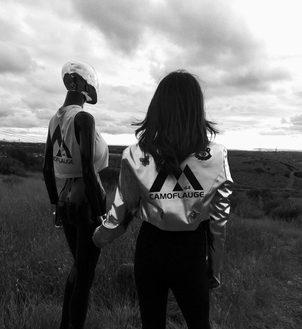 a dimensional being and woman standing in a field