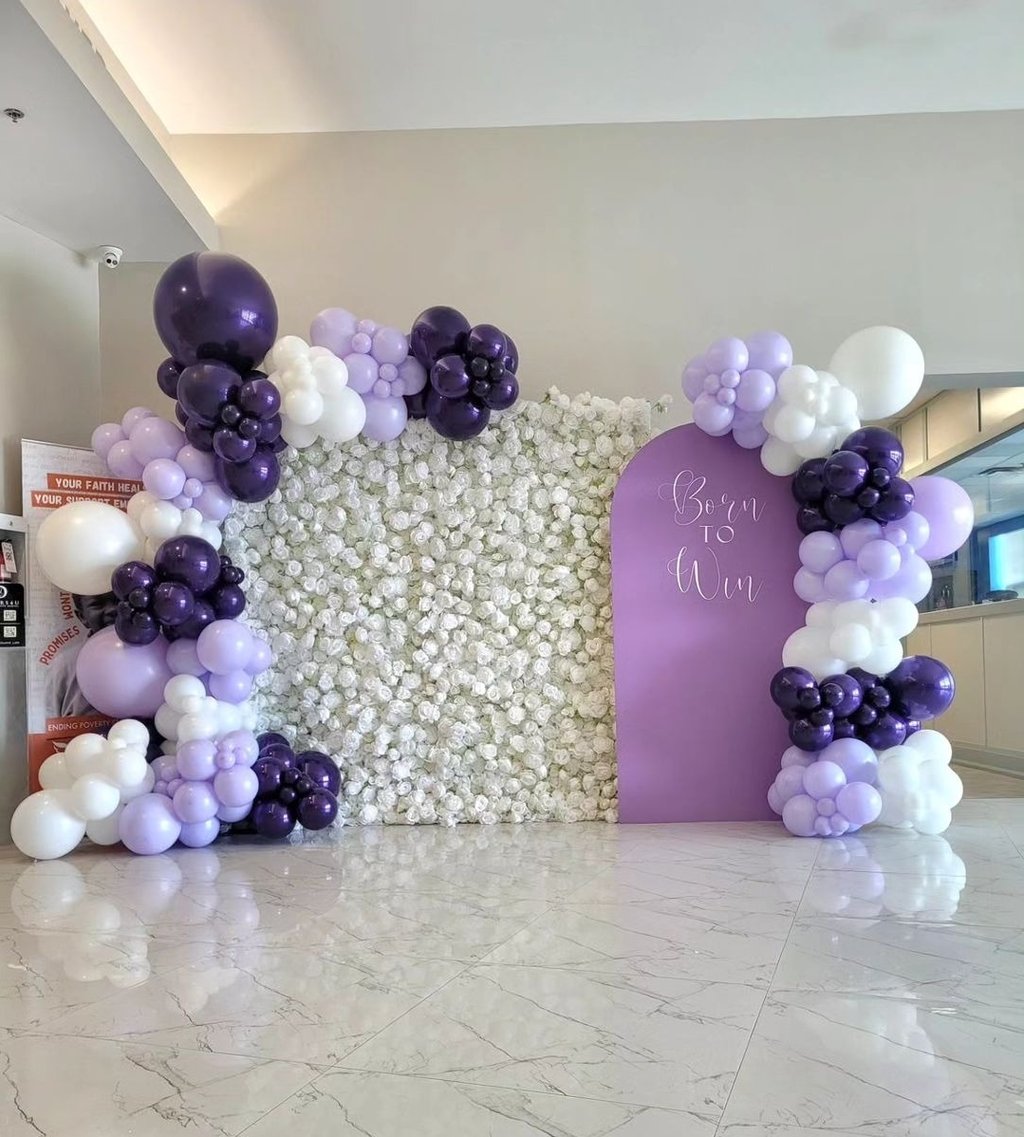 Born to win themed balloon backdrop paired with our white rose flower wall