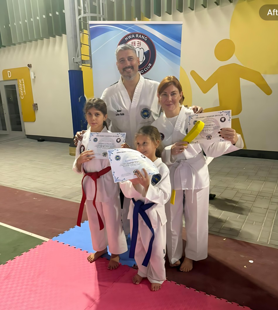 Master Carlos Bazan, 7th Dan & World Champion presenting new belts to family at a taekwondo Exam