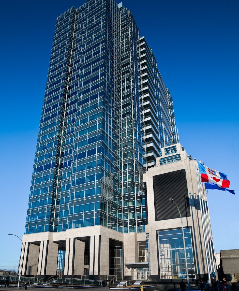 a tall building with a flag flying in the sky