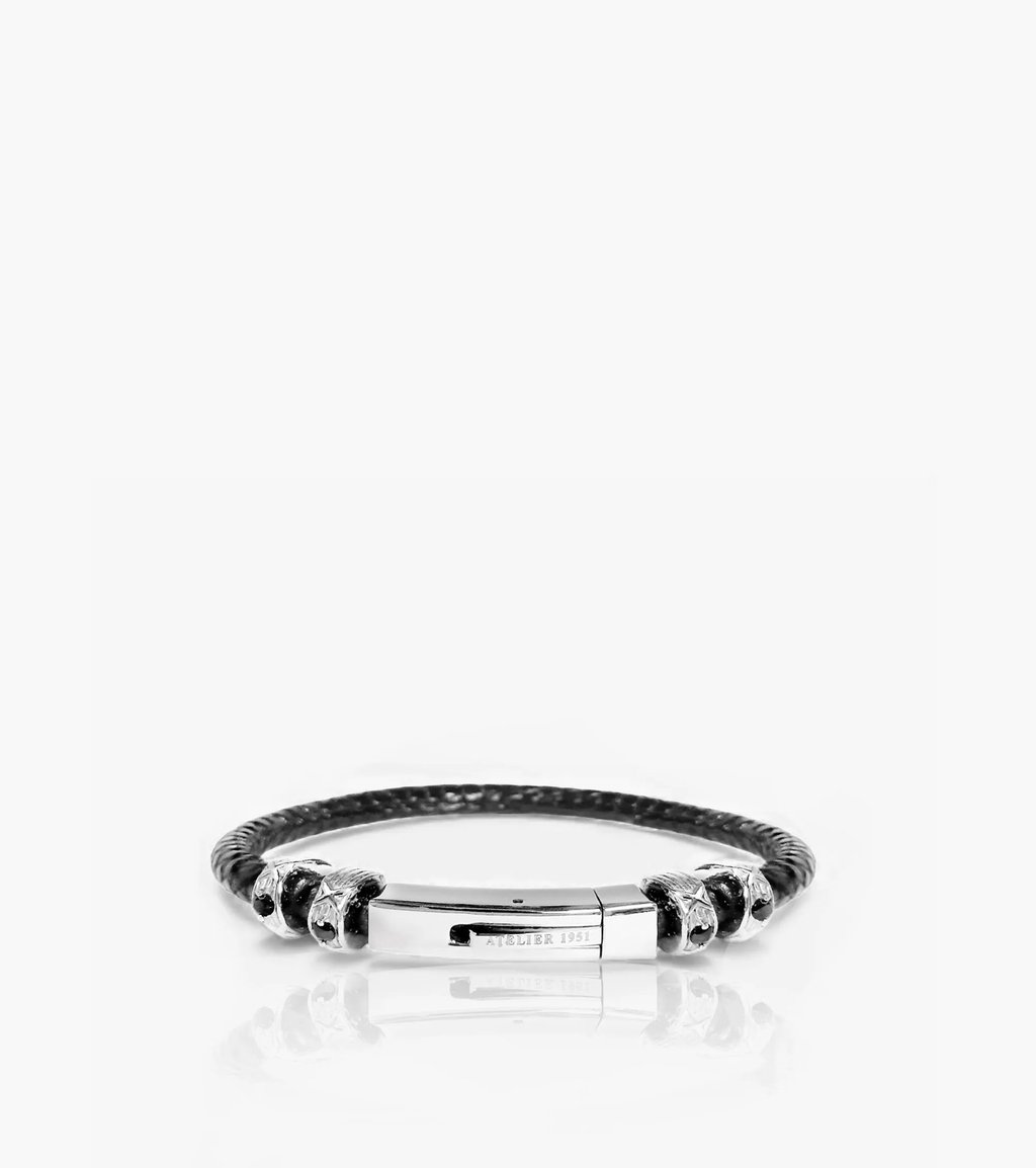 Unisex black braided leather bracelet with a polished silver clasp and decorative charms.