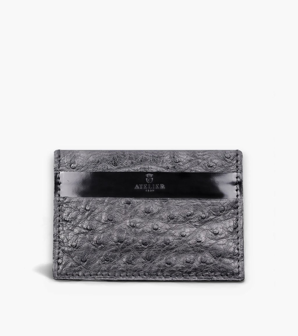 Luxury grey ostrich leather card holder featuring a black accent strip and Atelier logo.