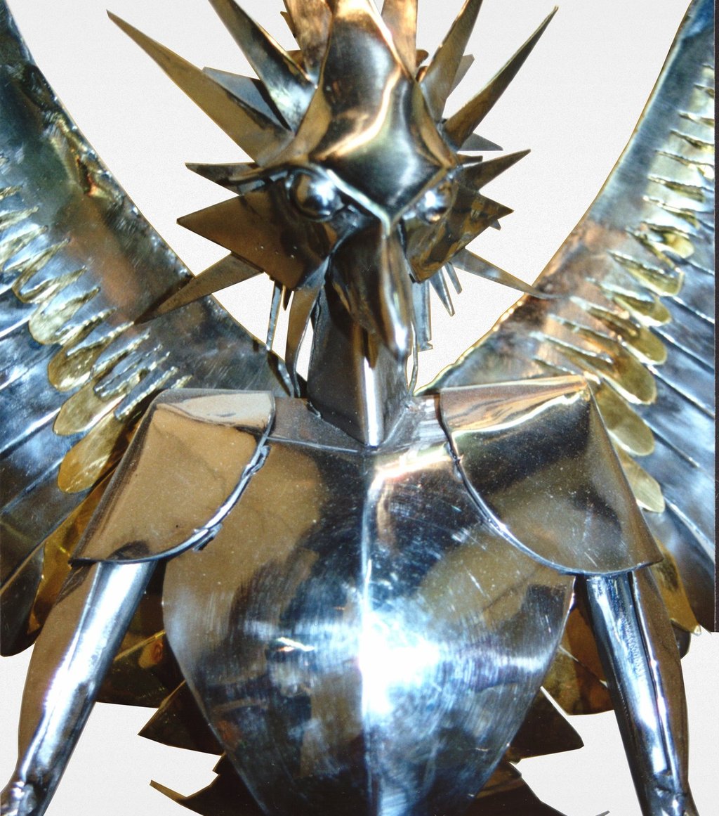 a chrome statue of a phoenix close up