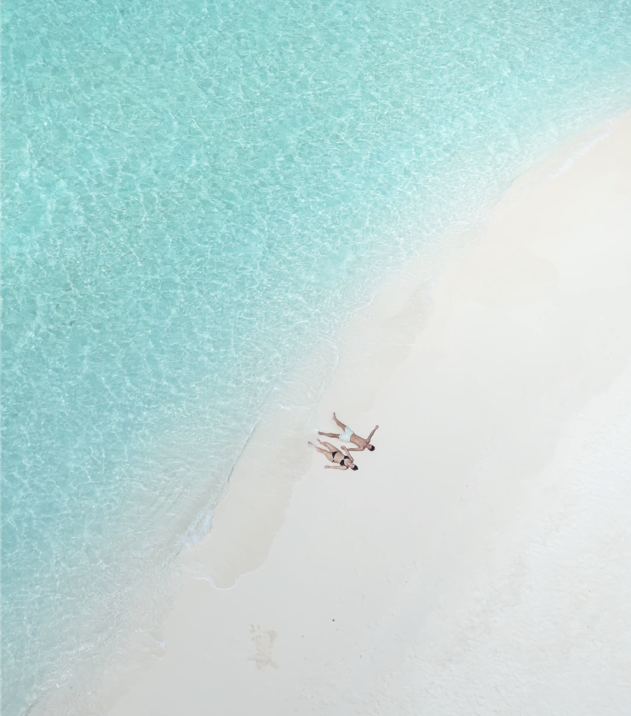 Customised your trip. A couple on a sandbank enjoy their private time with the nature, the ocean.