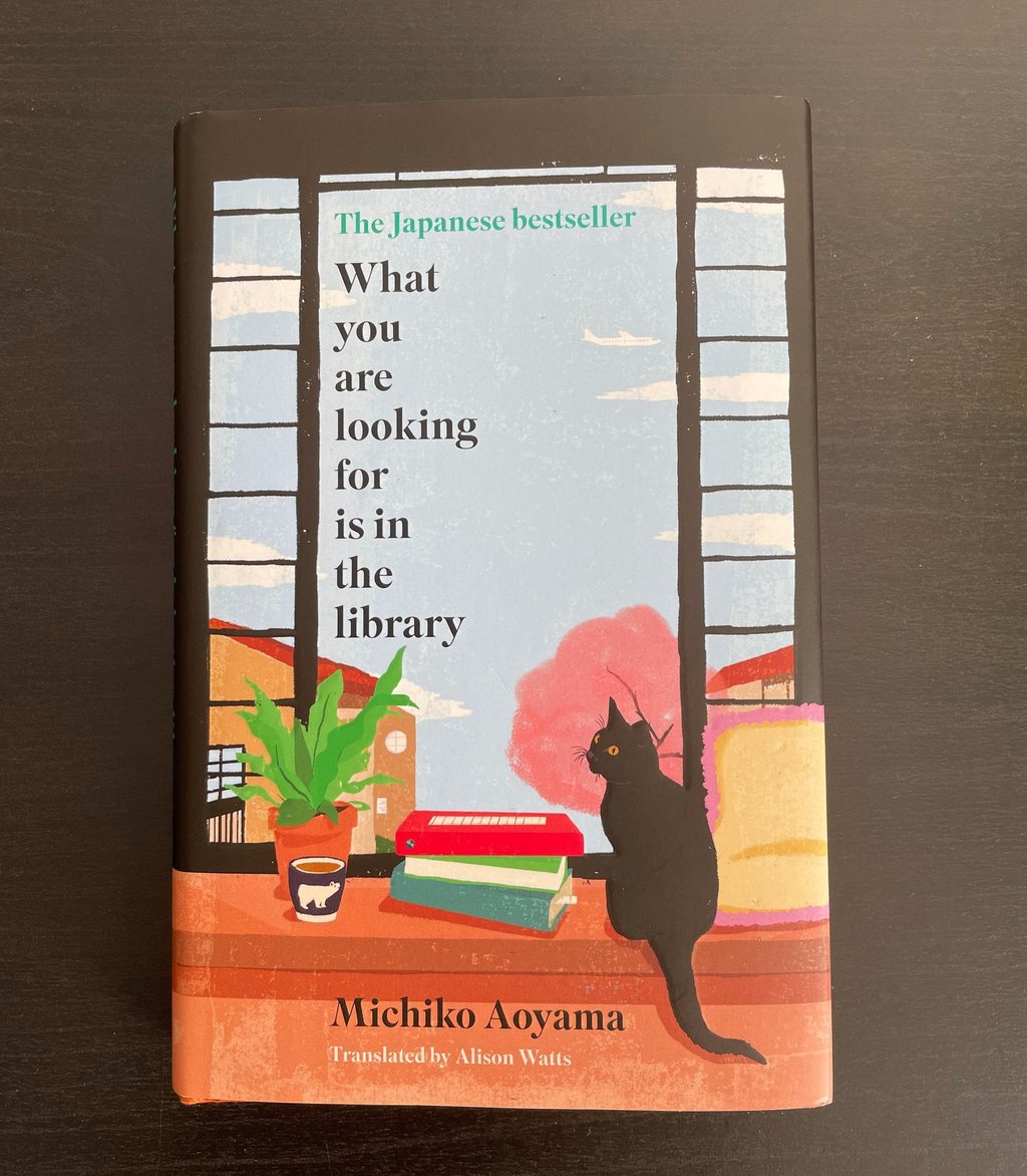 a book with a cat sitting on a table. What you are looking for is in the library