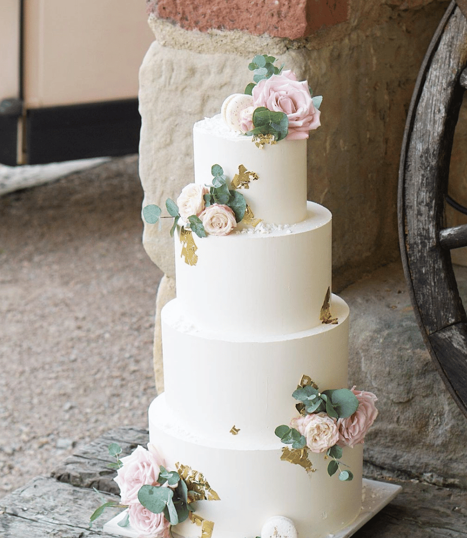 a wedding cake with flowers on top of it