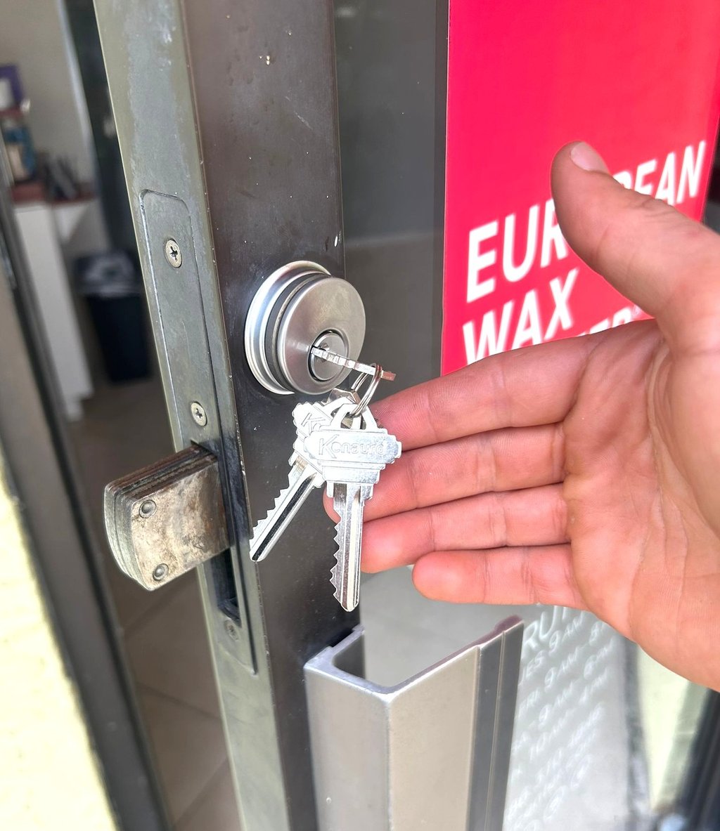 commercial locksmith repairing and rekeying a business door lock in Flagler County
