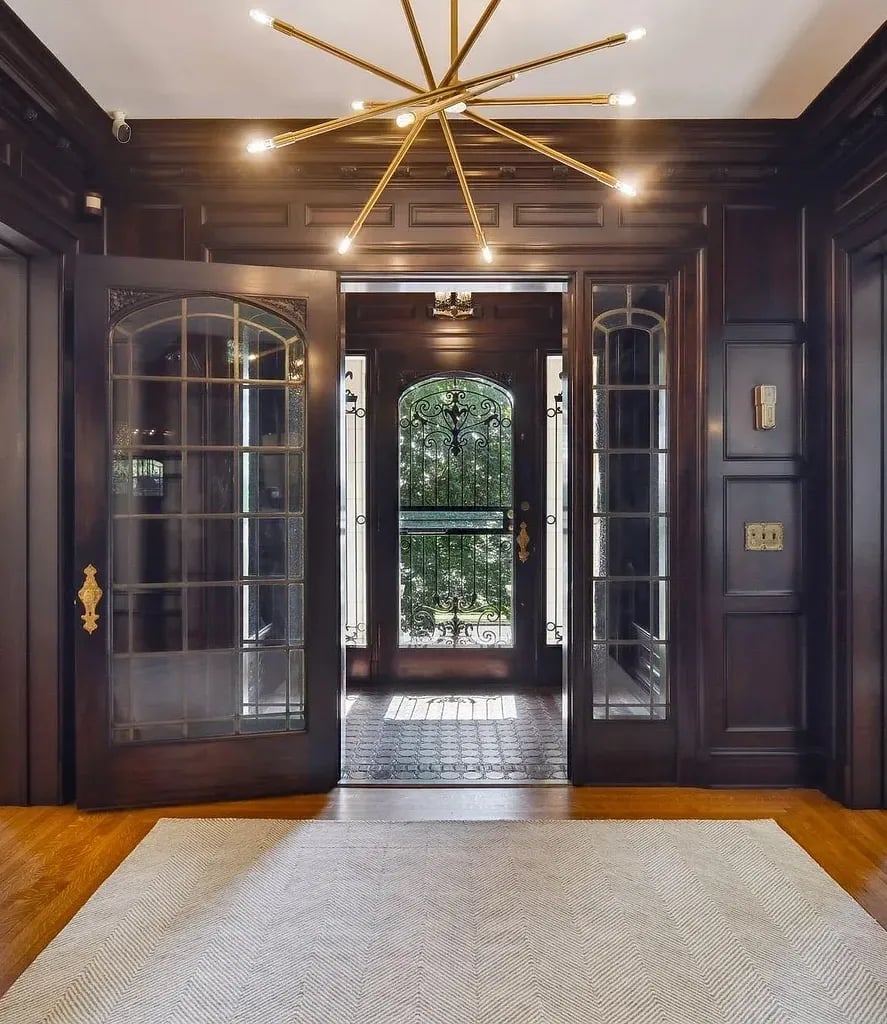 a large foyer with a chandelier and a chandelier