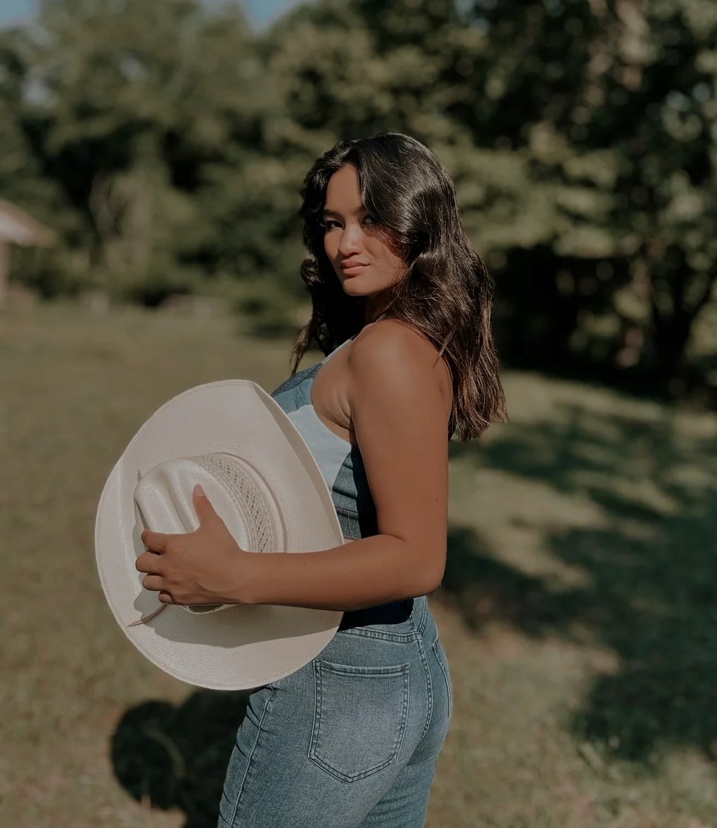 Amelia posing in a jeans top and jeans 