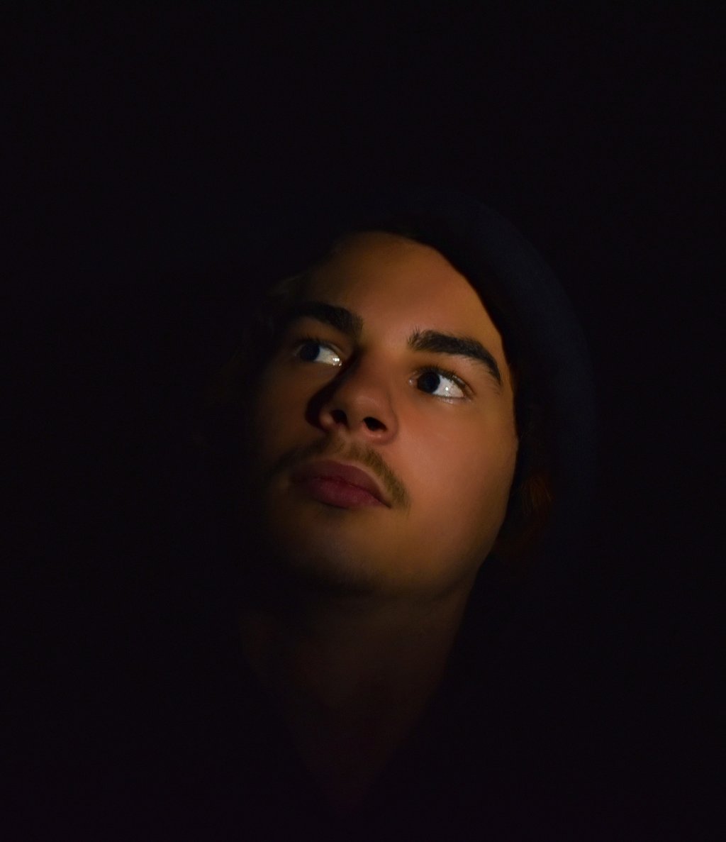 a man with a hoodie and and vigilante lighting