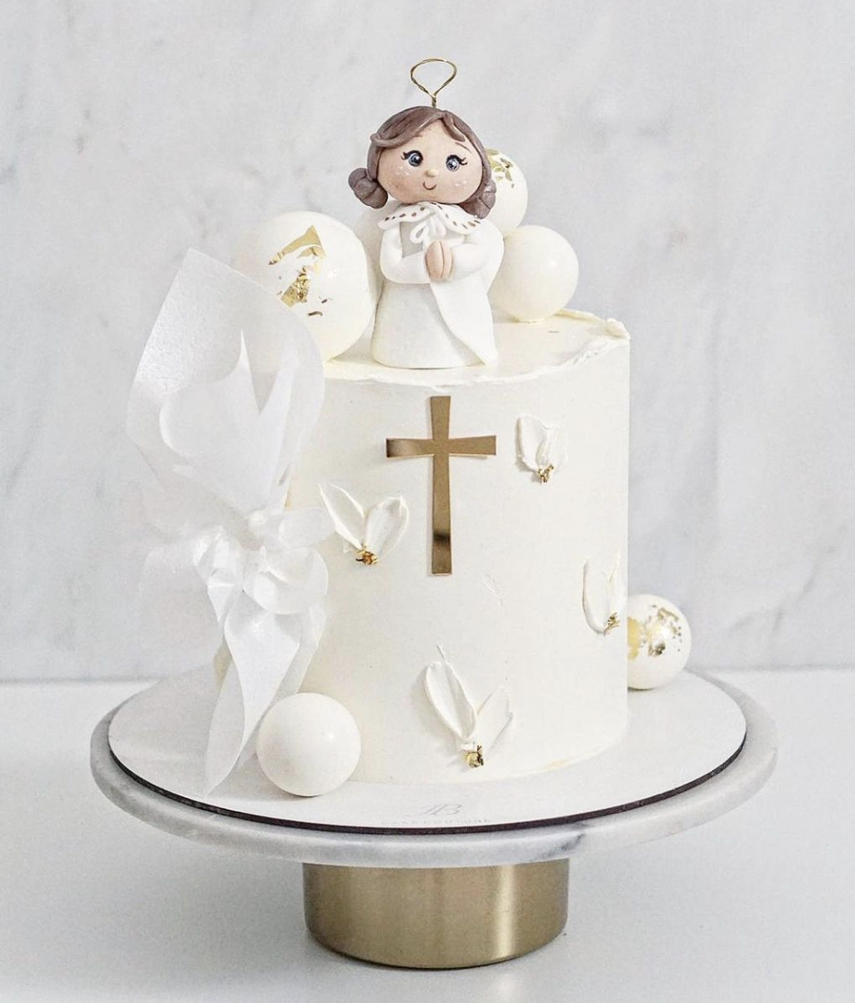 a cake with a little angel on top of it