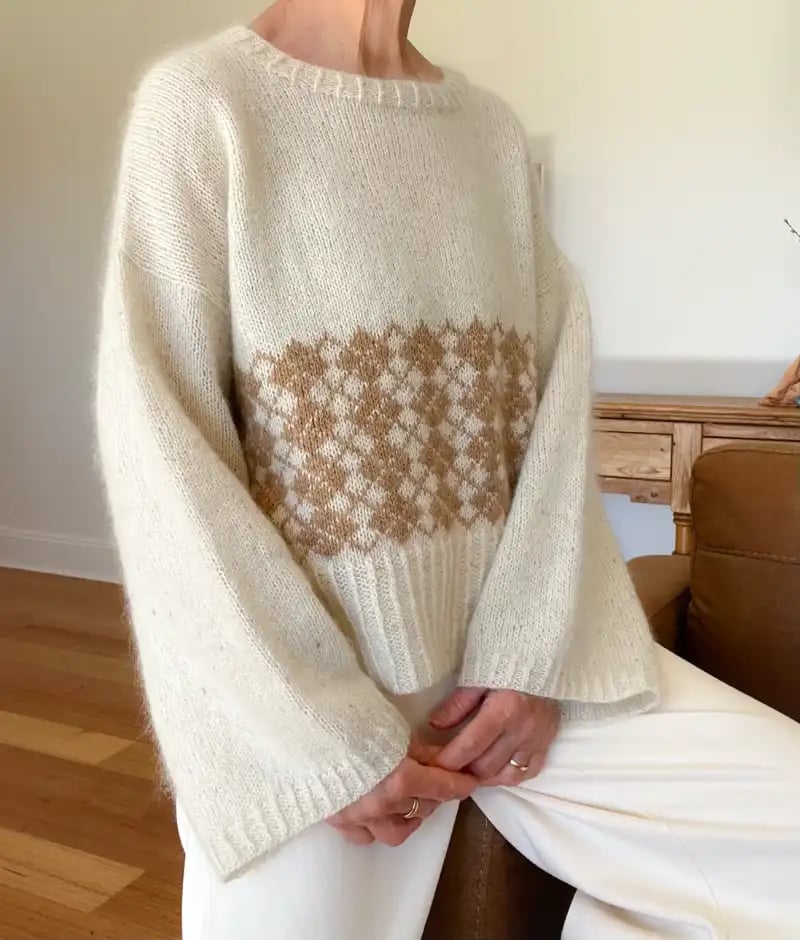 Paddock and Purl Studio Instructor Marie wearing a beautiful hand knit in cream and brown she created