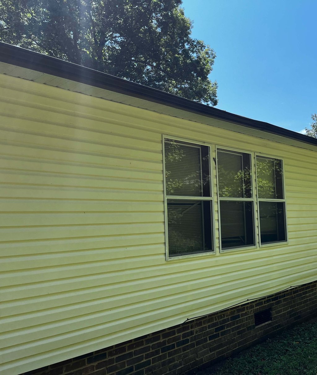 After: spotless white vinyl siding on Lenoir NC house—soft wash removes all grime, mildew-free and bright