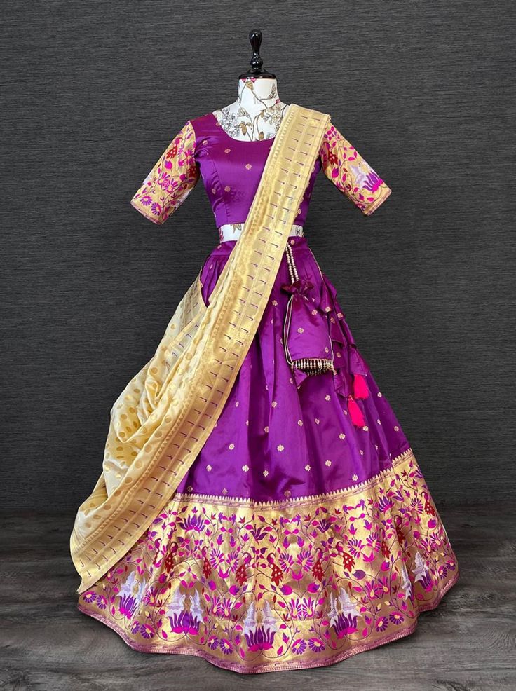 a purple and gold colored silk and gold threadwork work lehenga