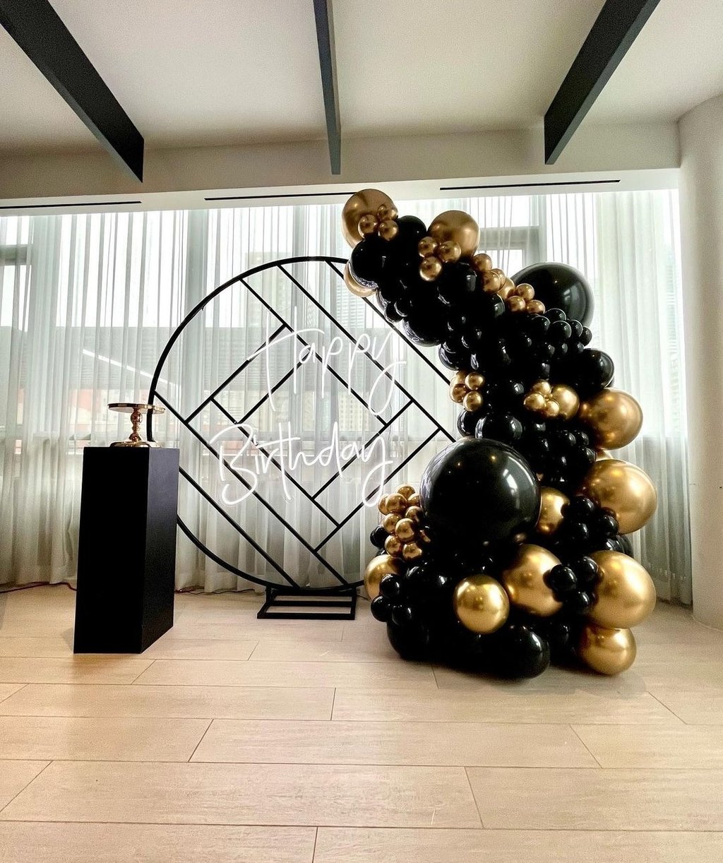 Black and gold balloon backdrop rental